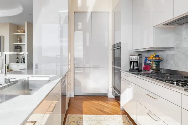 a kitchen with stainless steel appliances granite countertop a sink and a refrigerator