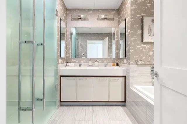 a bathroom with a sink double vanity and a mirror