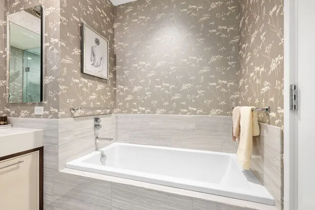 a bathroom with bathtub and shower