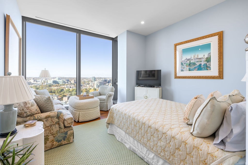 1 Dalton Street, Unit 3205 Boston, MA 02115 - Photo 22 of 42 a bedroom with a bed and large windows