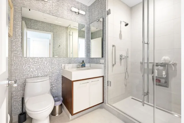 a bathroom with a toilet sink and a shower