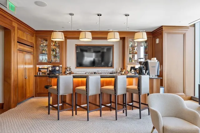 a living room with furniture a flat screen tv and outdoor view