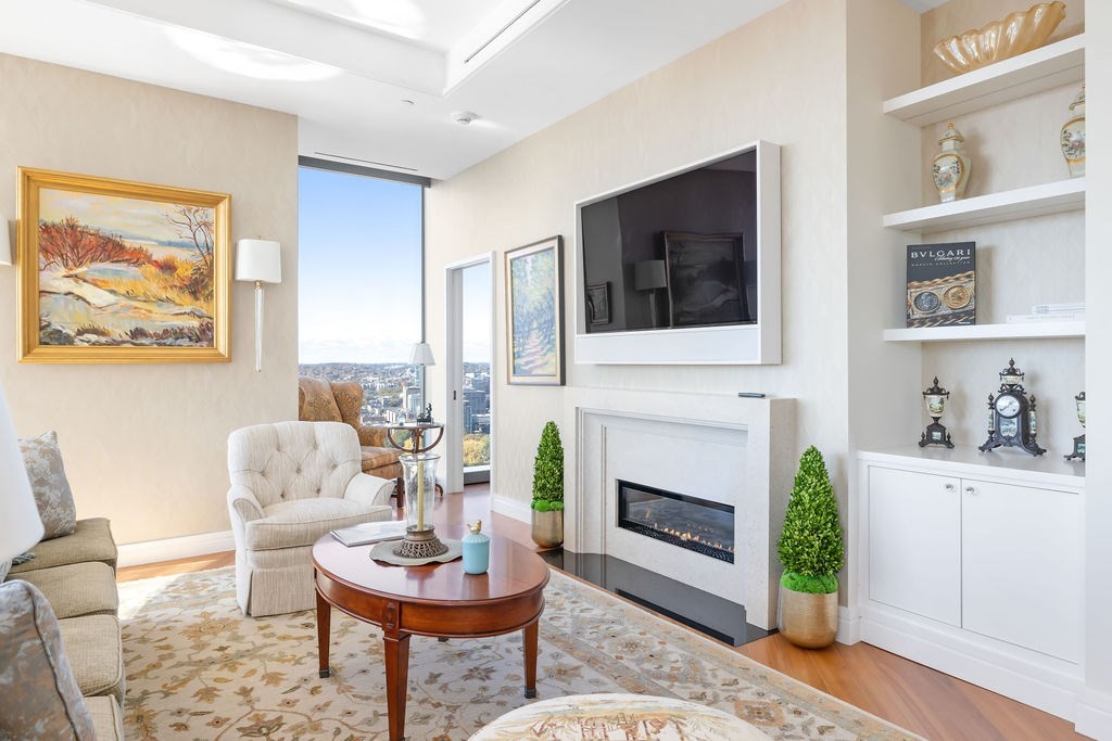 1 Dalton Street, Unit 3205 Boston, MA 02115 - Photo 4 of 42 a living room with furniture a fireplace and next to a window