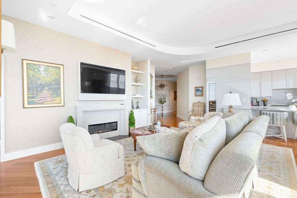 1 Dalton Street, Unit 3205 Boston, MA 02115 - Photo 5 of 42 a living room with furniture a fireplace and a flat screen tv