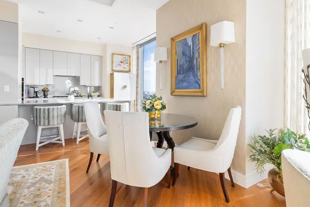 a view of a dining room with furniture wooden floor and a chandelier
