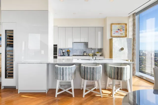 a kitchen with a table chairs refrigerator and cabinets