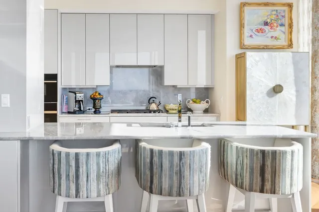 a kitchen with stainless steel appliances granite countertop a sink a stove and a refrigerator with wooden floor