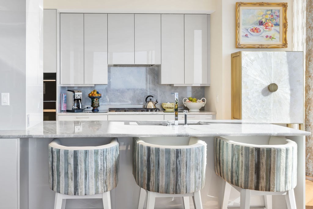 1 Dalton Street, Unit 3205 Boston, MA 02115 - Photo 10 of 42 a kitchen with stainless steel appliances granite countertop a sink a stove and a refrigerator with wooden floor