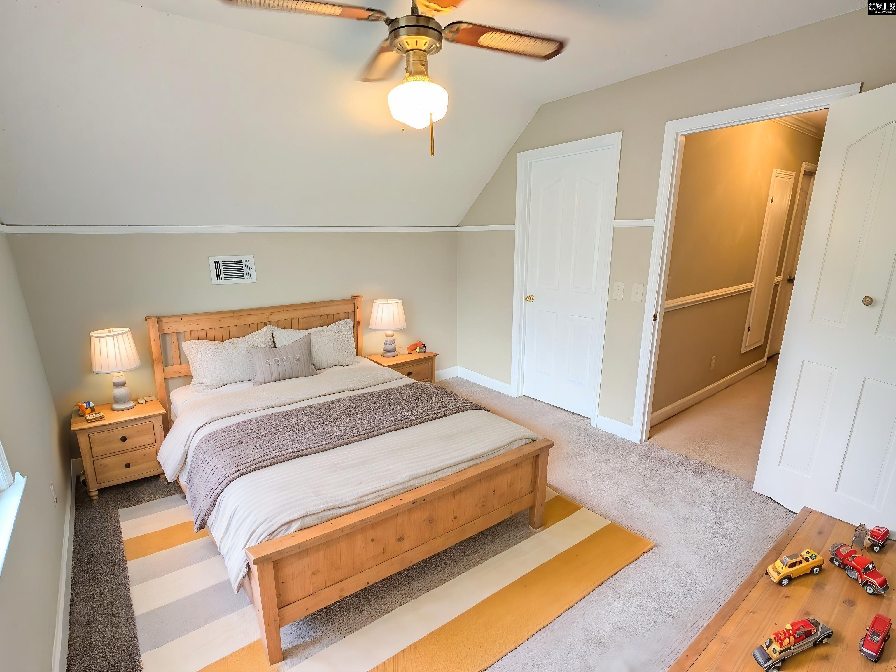 100 Welsh Court Lexington, SC 29073 - Photo 22 of 27 a bedroom with a bed and wooden floor