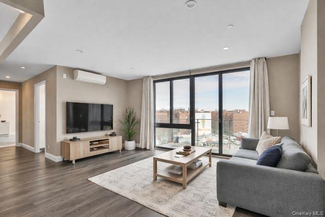 45-16 83rd Street, Unit E8F Queens, NY 11373 - Photo 2 of 19 a living room with furniture and a flat screen tv