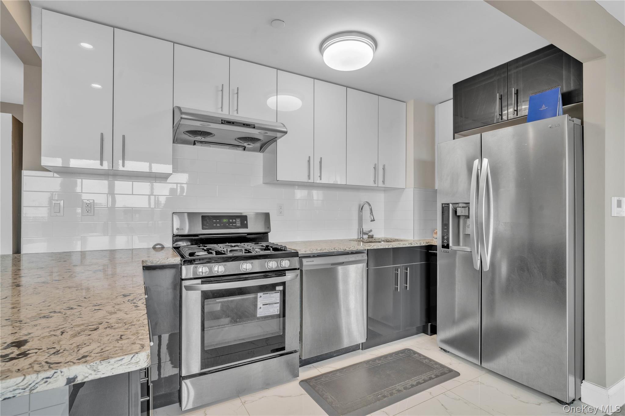 45-16 83rd Street, Unit E8F Queens, NY 11373 - Photo 6 of 19 a kitchen with a stove sink and refrigerator