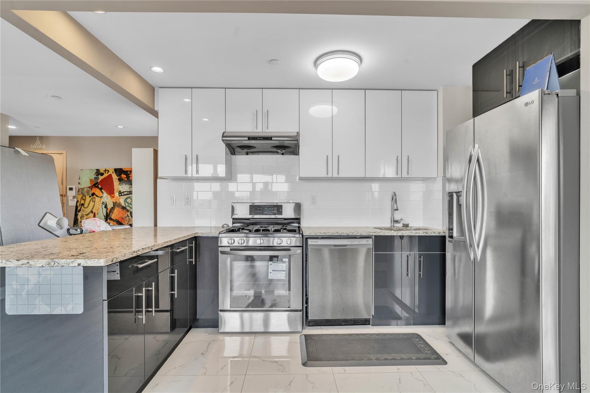 45-16 83rd Street, Unit E8F Queens, NY 11373 - Photo 7 of 19 a kitchen with stainless steel appliances a stove a refrigerator and a sink
