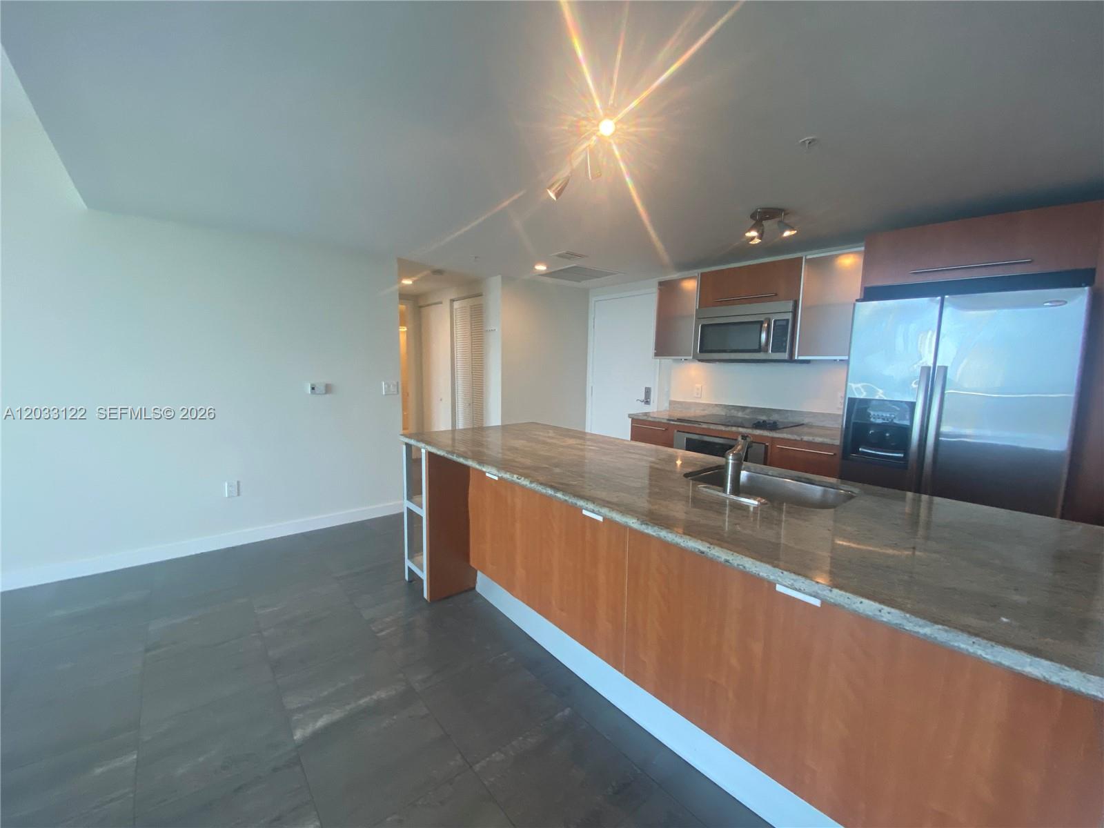 185 Southwest 7th Street, Unit 4206 Miami, FL 33130 - Photo 10 of 26 a large white kitchen with a large window