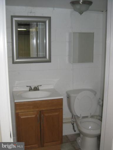 59 Hawthorne Road Middle River, MD 21220 - Photo 12 of 18 a bathroom with a toilet sink vanity and mirror