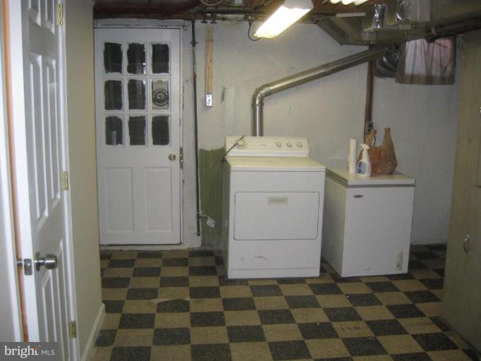 59 Hawthorne Road Middle River, MD 21220 - Photo 15 of 18 a room with a black white checkered floor with white walls