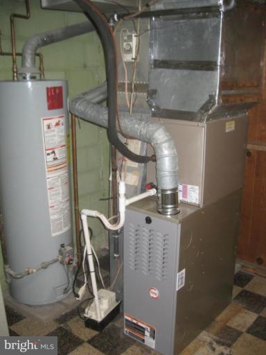 59 Hawthorne Road Middle River, MD 21220 - Photo 16 of 18 a view of a room with water heater and racks