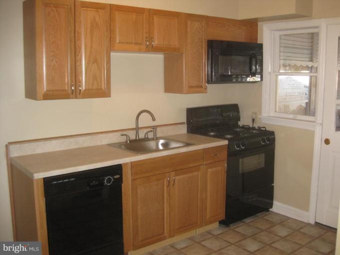 59 Hawthorne Road Middle River, MD 21220 - Photo 6 of 18 a kitchen with a sink and a microwave