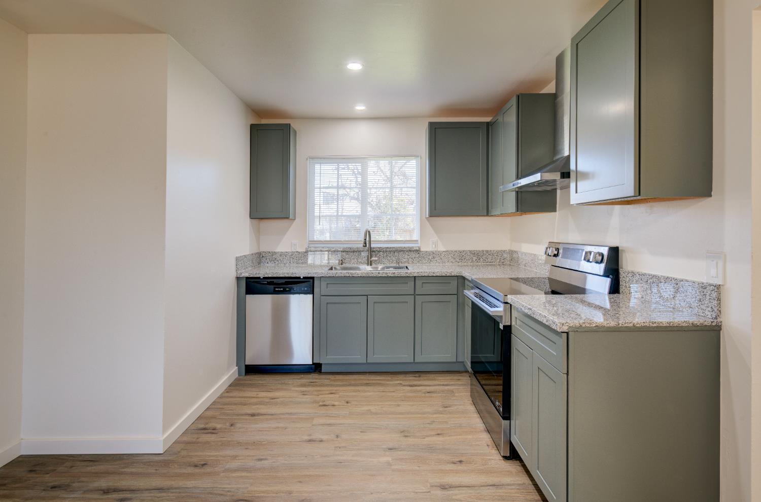 4722 North Callisch Street Fresno, CA 93726 - Photo 13 of 37 a kitchen with stainless steel appliances granite countertop a sink stove and cabinets