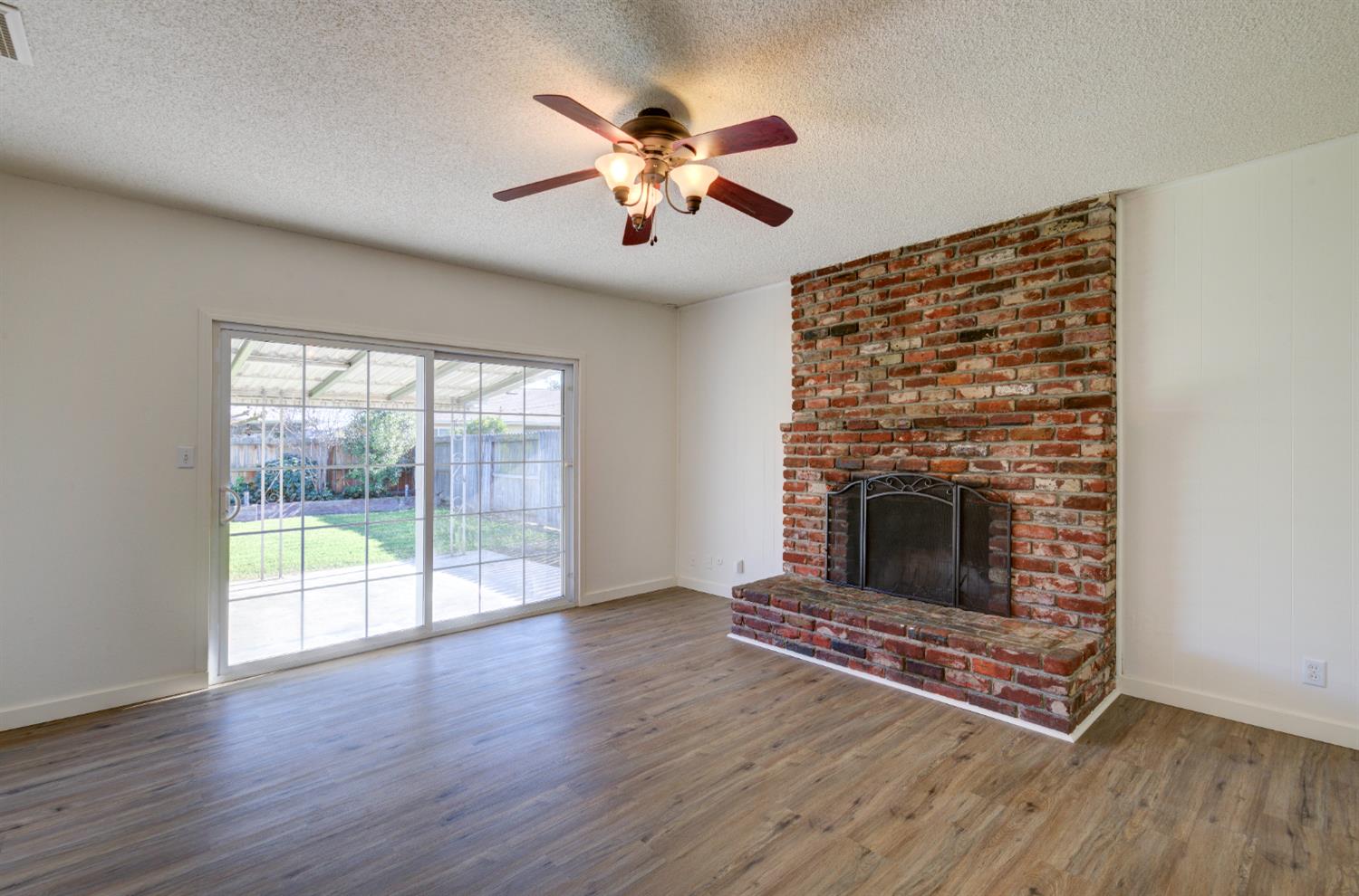 4722 North Callisch Street Fresno, CA 93726 - Photo 16 of 37 a living room with furniture and a fireplace