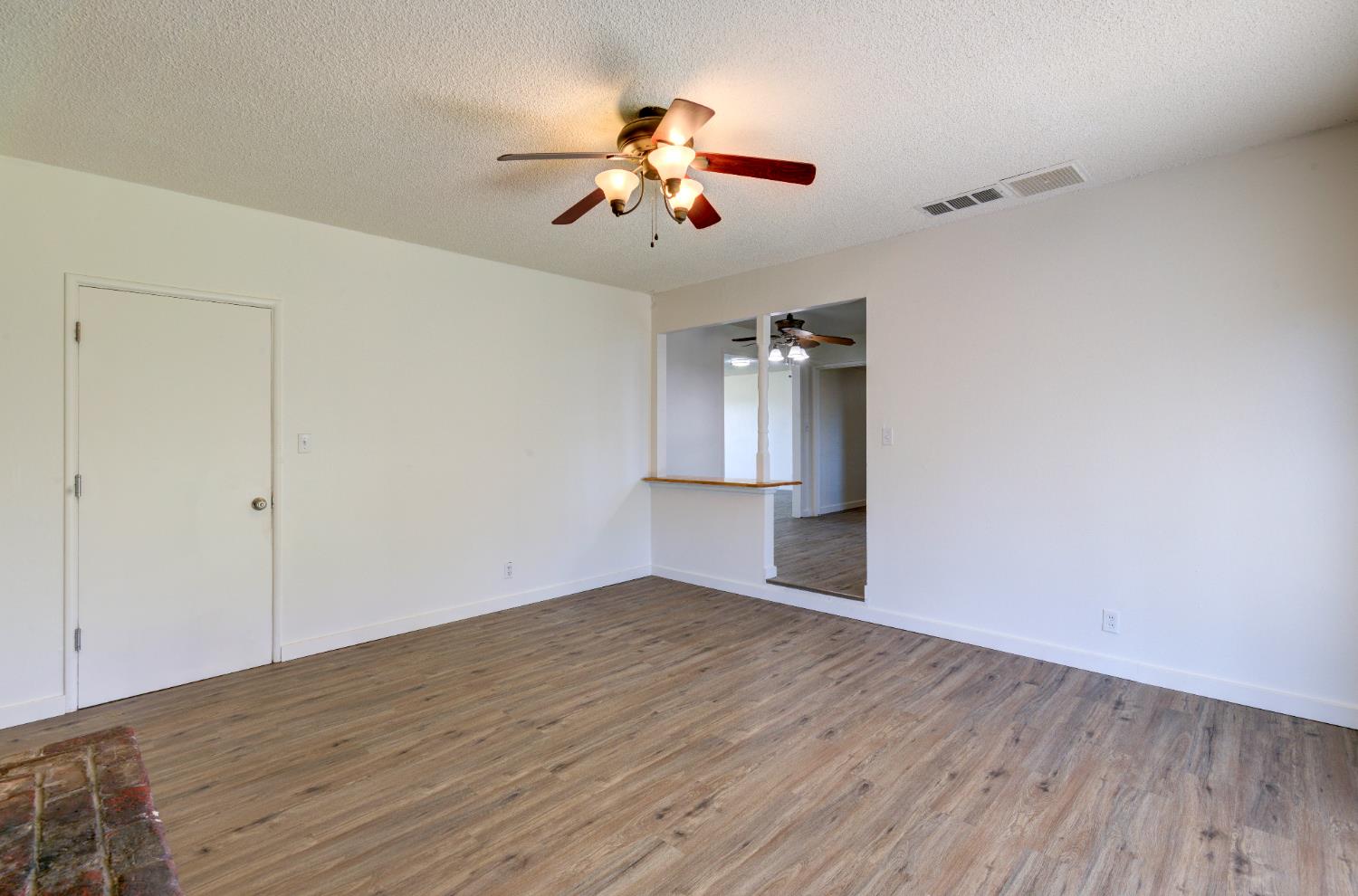 4722 North Callisch Street Fresno, CA 93726 - Photo 18 of 37 wooden floor in an empty room with a window