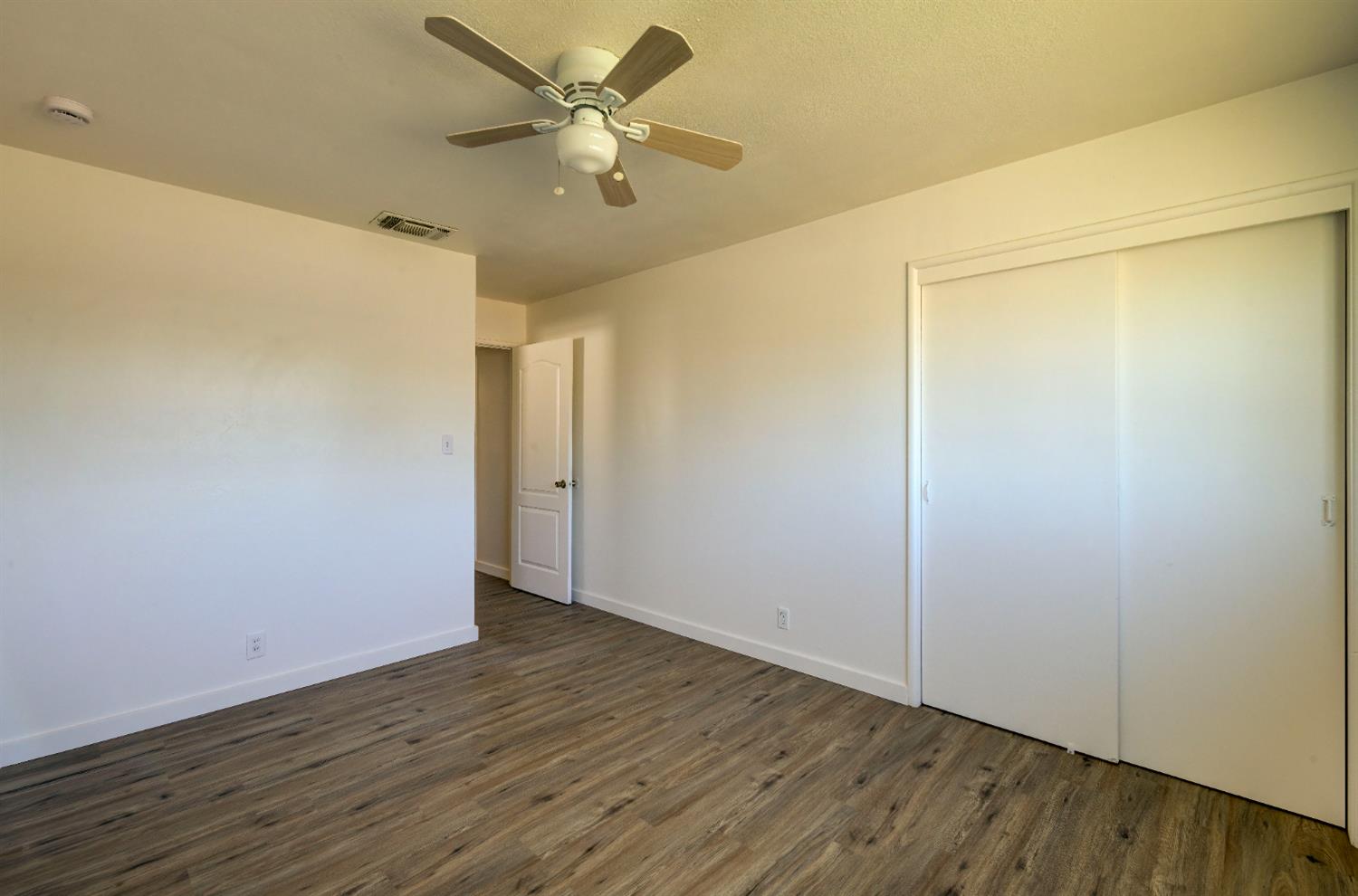 4722 North Callisch Street Fresno, CA 93726 - Photo 20 of 37 a view of an empty room with wooden floor
