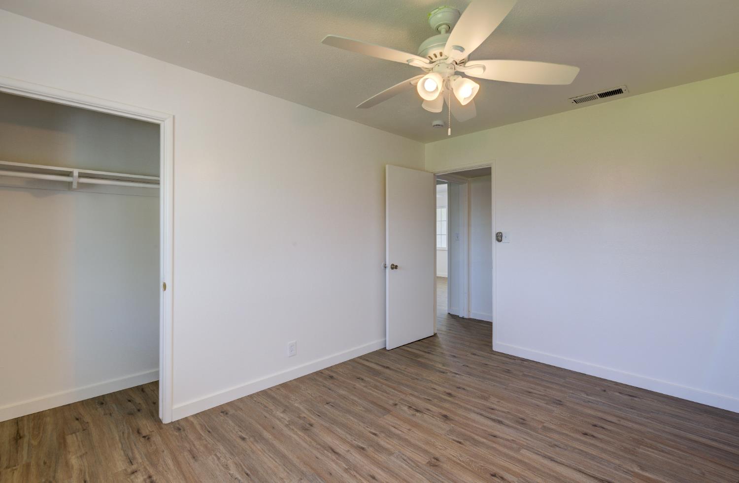 4722 North Callisch Street Fresno, CA 93726 - Photo 23 of 37 a view of an empty room with wooden floor