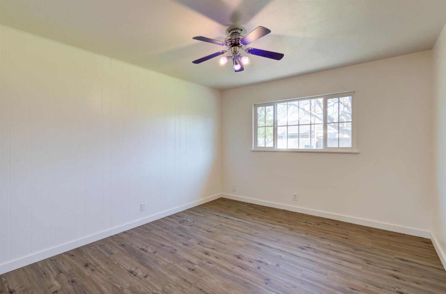 4722 North Callisch Street Fresno, CA 93726 - Photo 24 of 37 an empty room with wooden floor and windows