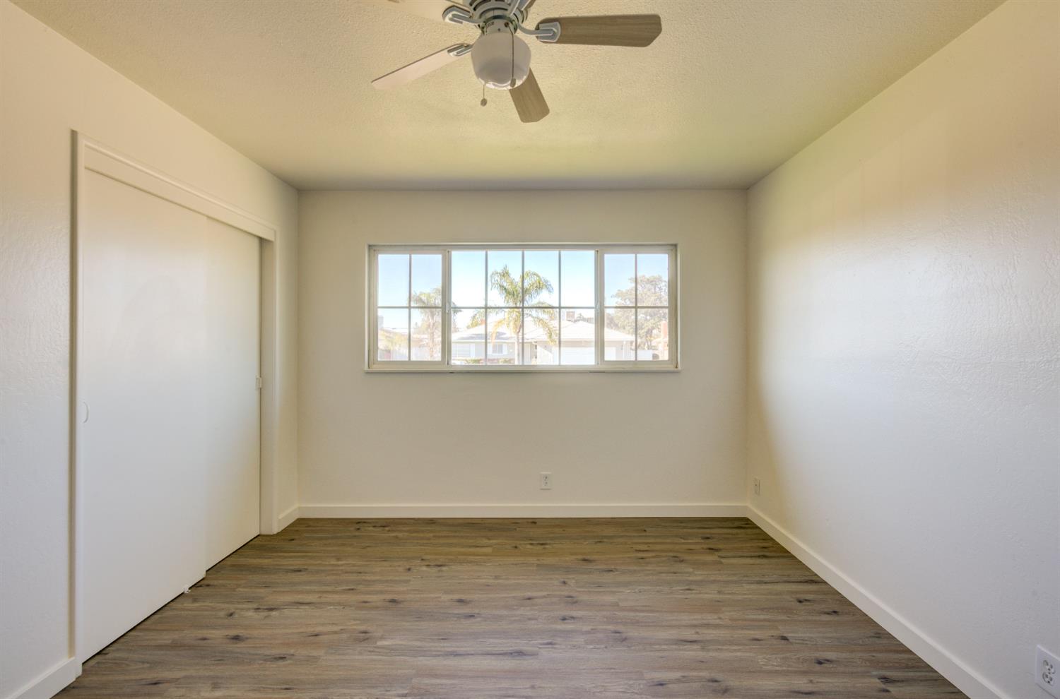 4722 North Callisch Street Fresno, CA 93726 - Photo 27 of 37 wooden floor in an empty room with a window
