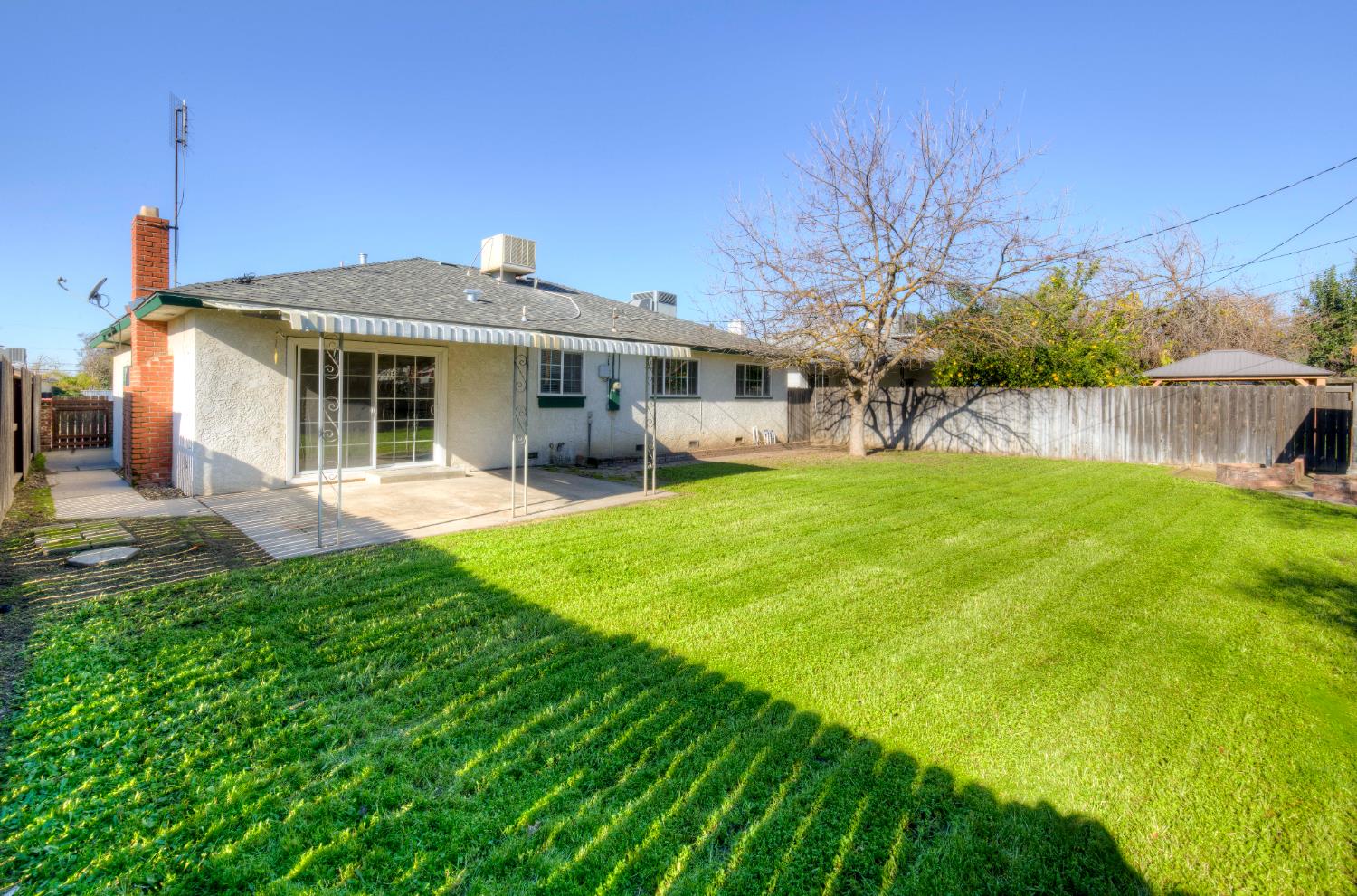 4722 North Callisch Street Fresno, CA 93726 - Photo 32 of 37 a view of a house with a yard porch and sitting area