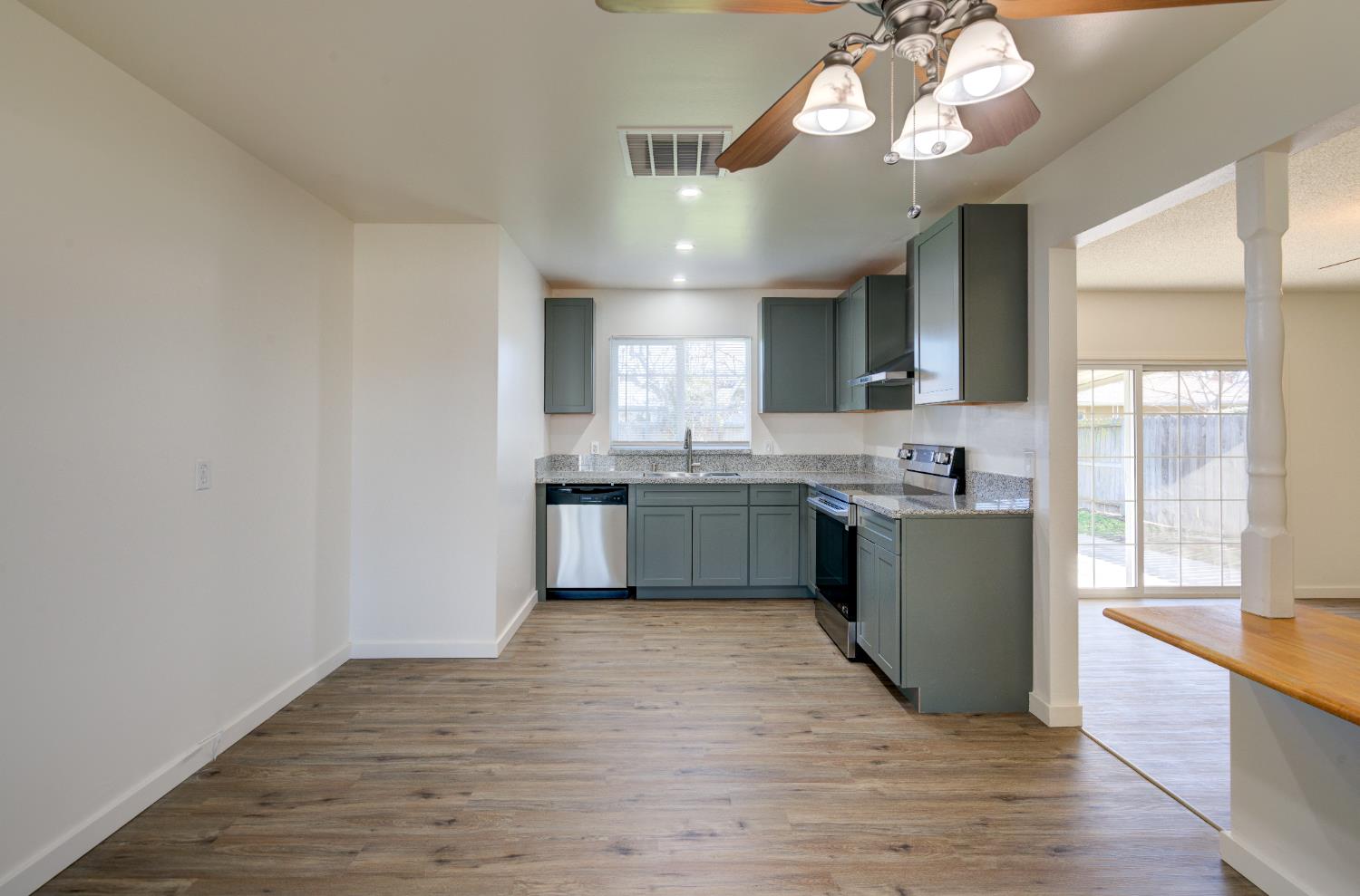 4722 North Callisch Street Fresno, CA 93726 - Photo 10 of 37 a large kitchen with a large counter space a sink appliances and cabinets