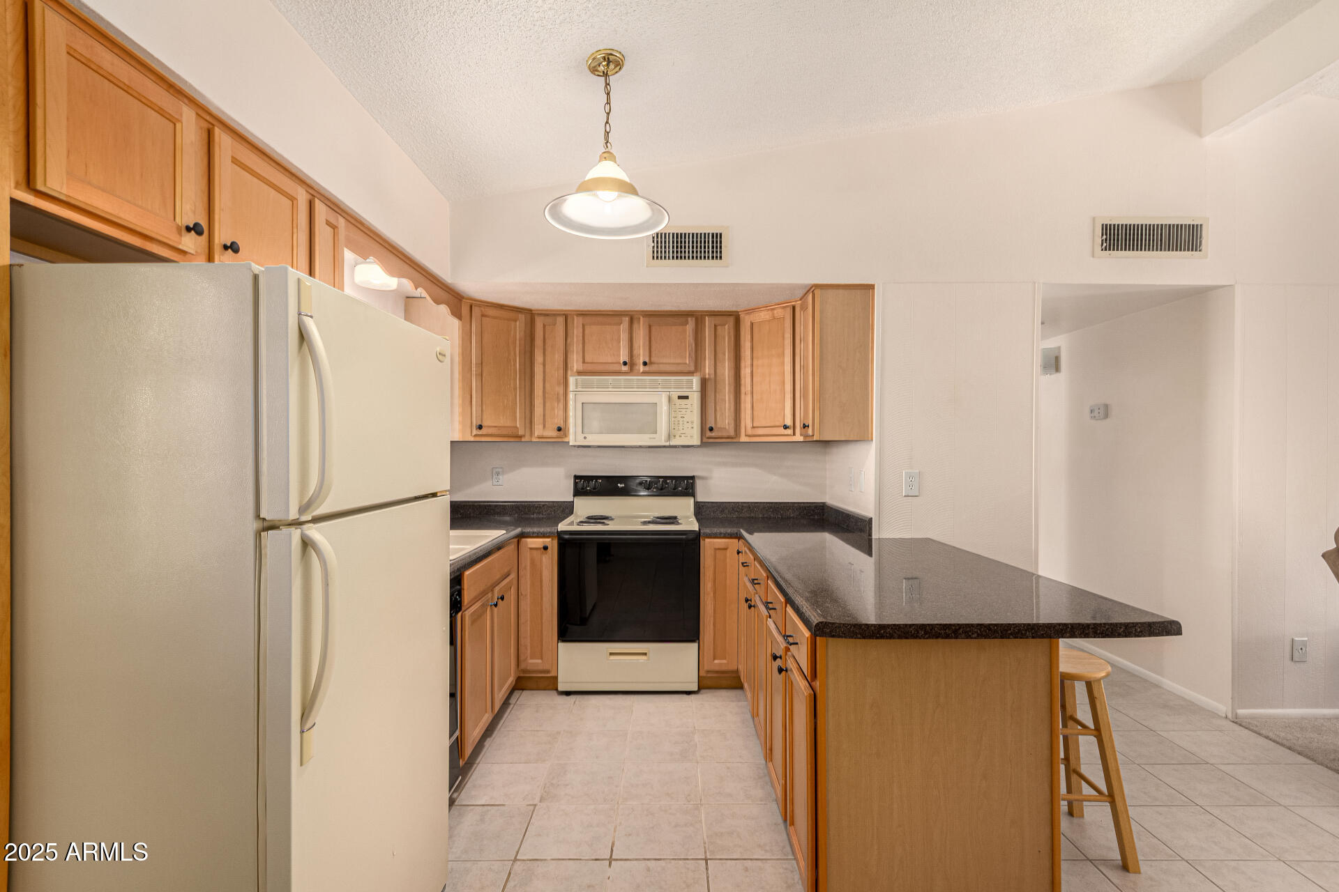 641 South Power Road, Unit 364 Mesa, AZ 85206 - Photo 12 of 32 a kitchen with stainless steel appliances granite countertop a refrigerator a sink dishwasher a stove with white cabinets and wooden floor