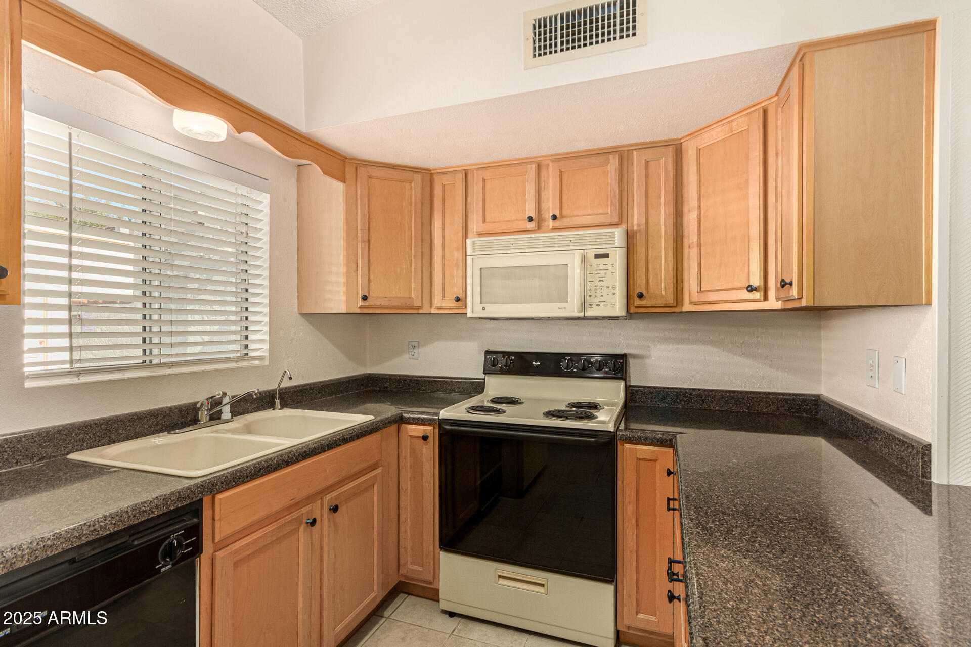 641 South Power Road, Unit 364 Mesa, AZ 85206 - Photo 13 of 32 a kitchen with stainless steel appliances granite countertop white cabinets and a stove top oven