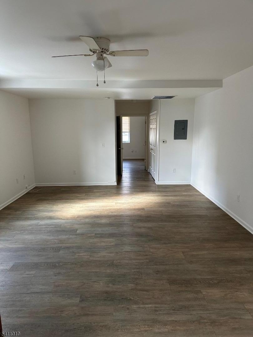 471 Pompton Avenue, Unit 3 Cedar Grove, NJ 07009 - Photo 2 of 7 a view of an empty room with wooden floor and a window