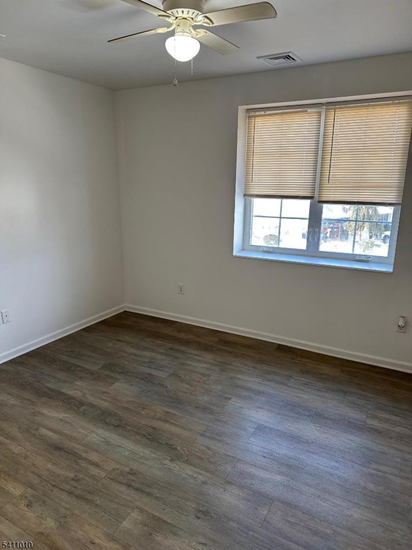 471 Pompton Avenue, Unit 3 Cedar Grove, NJ 07009 - Photo 6 of 7 an empty room with wooden floor and windows