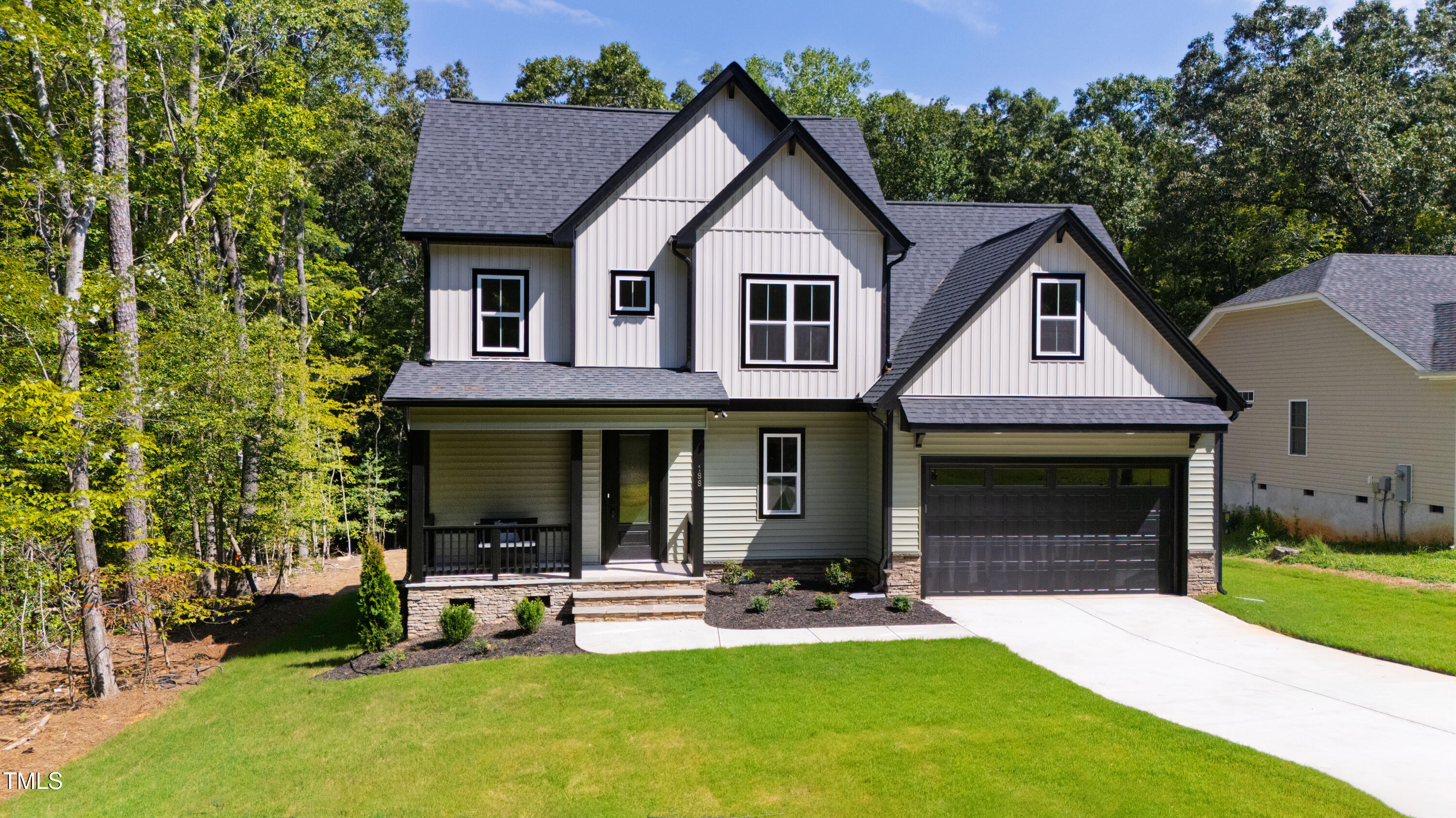 a front view of a house with a yard and porch