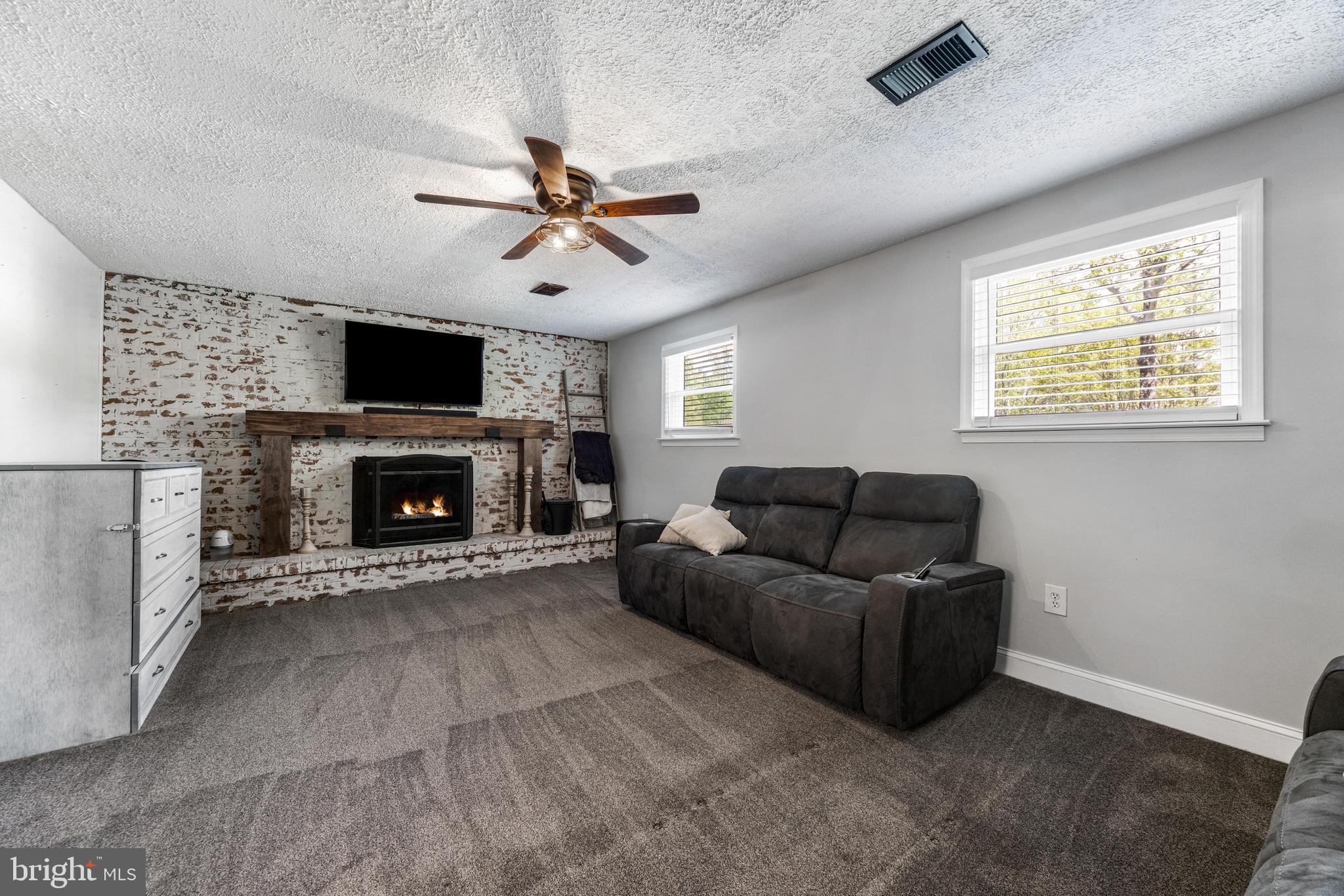 3006 Bass Place Riva, MD 21140 - Photo 23 of 51 a living room with furniture a flat screen tv and a fireplace