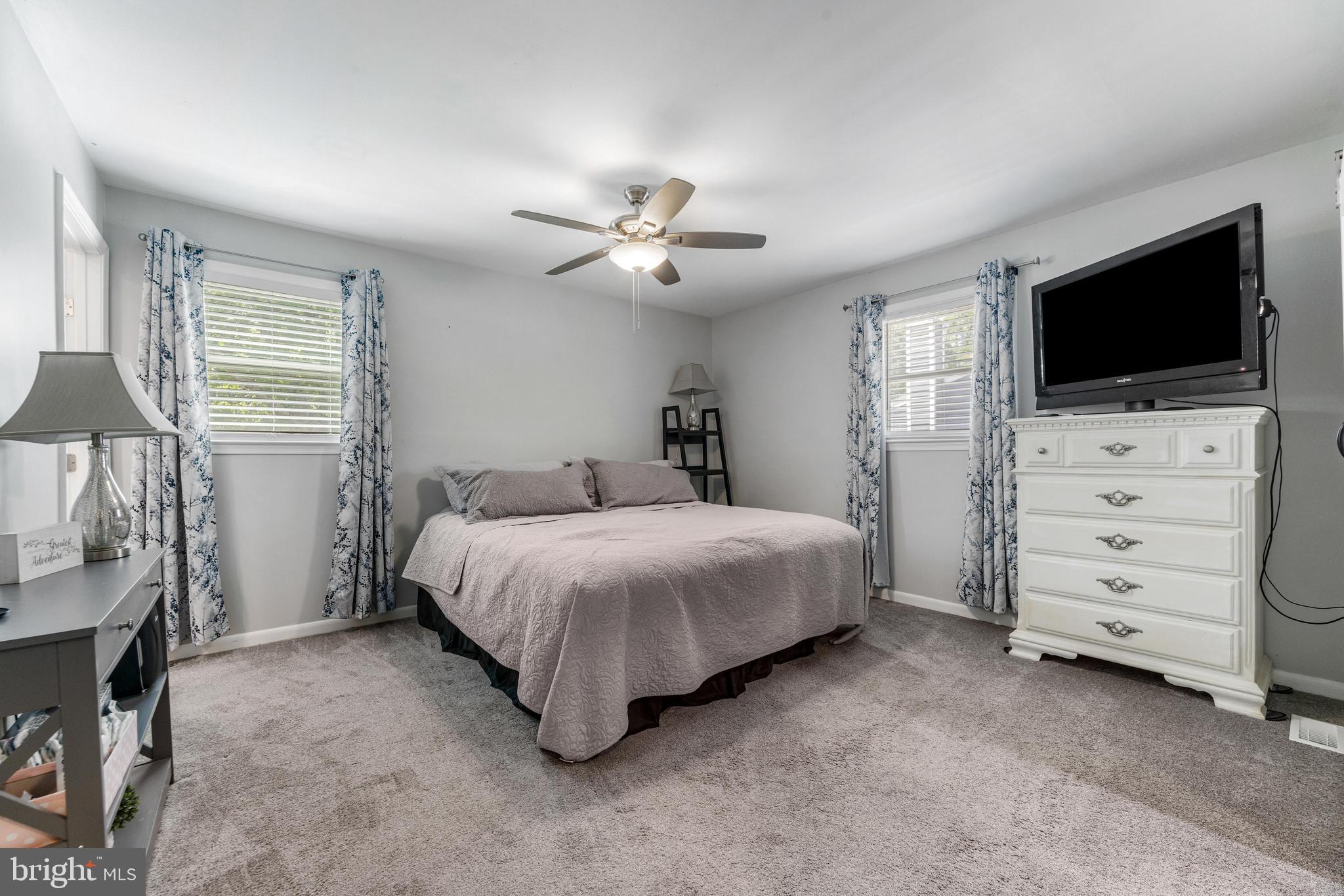 3006 Bass Place Riva, MD 21140 - Photo 29 of 51 a spacious bedroom with a bed and a flat screen tv