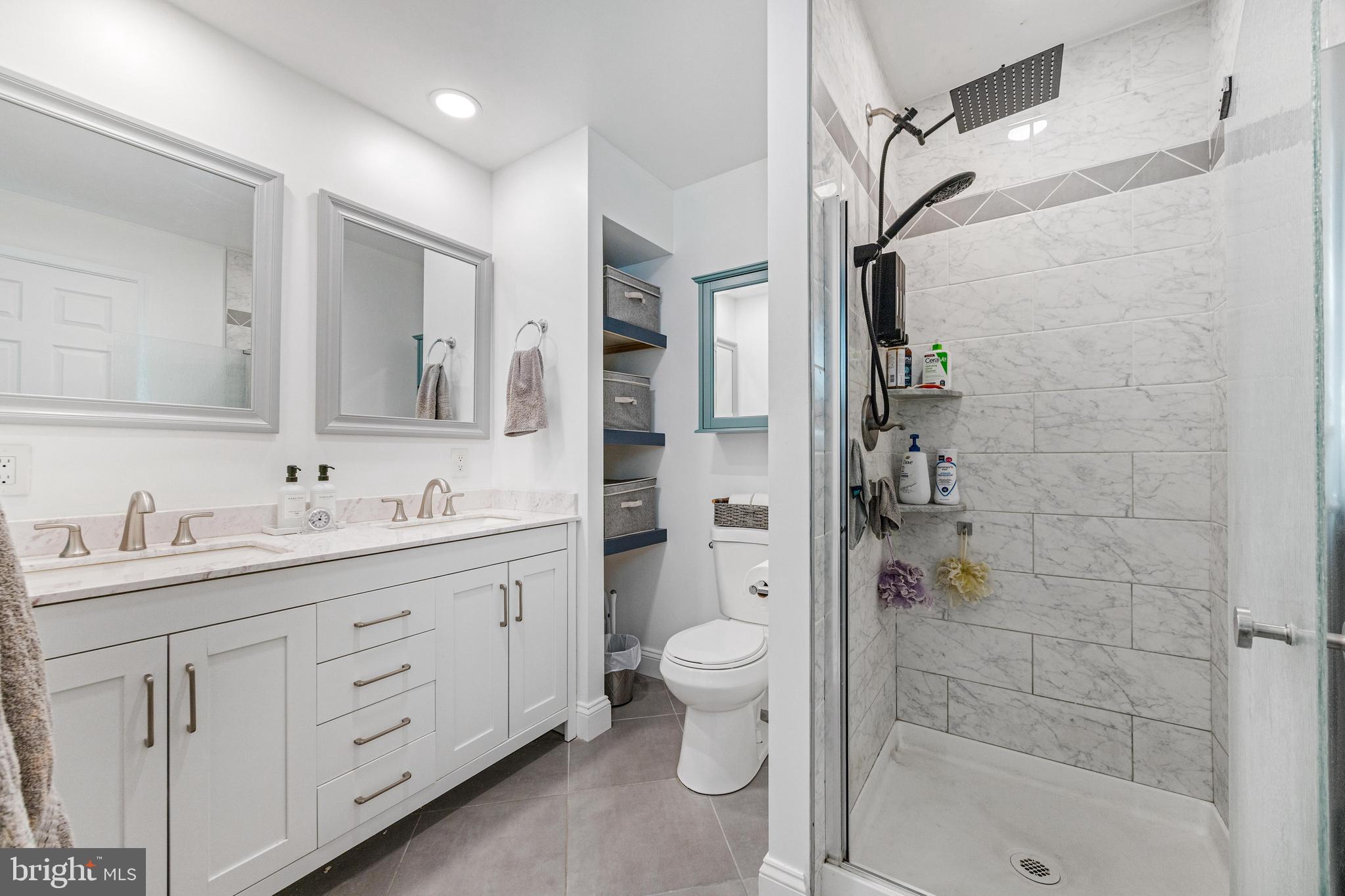 3006 Bass Place Riva, MD 21140 - Photo 35 of 51 a bathroom with a granite countertop sink a mirror a shower and a toilet
