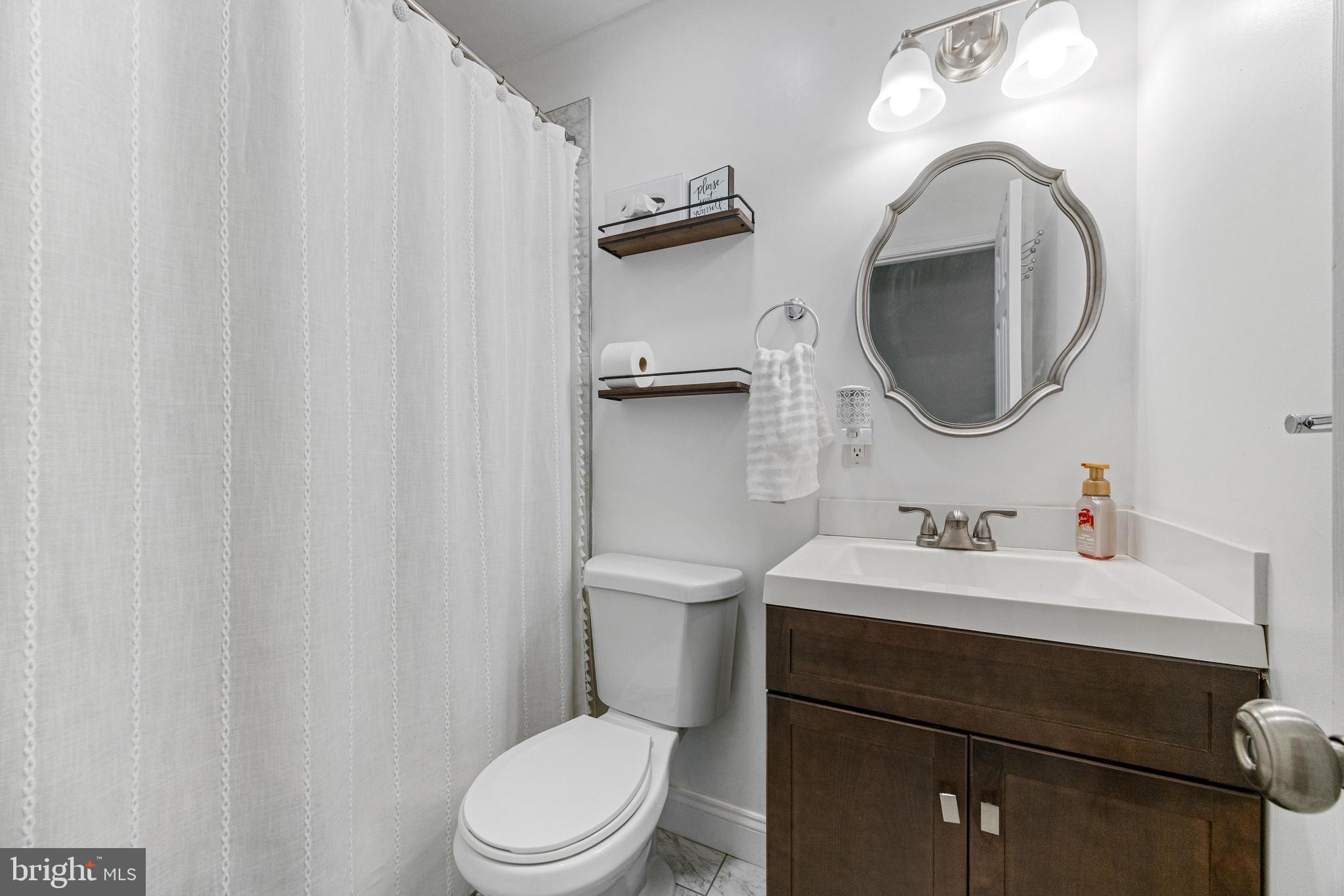 3006 Bass Place Riva, MD 21140 - Photo 41 of 51 a bathroom with a toilet a sink and mirror