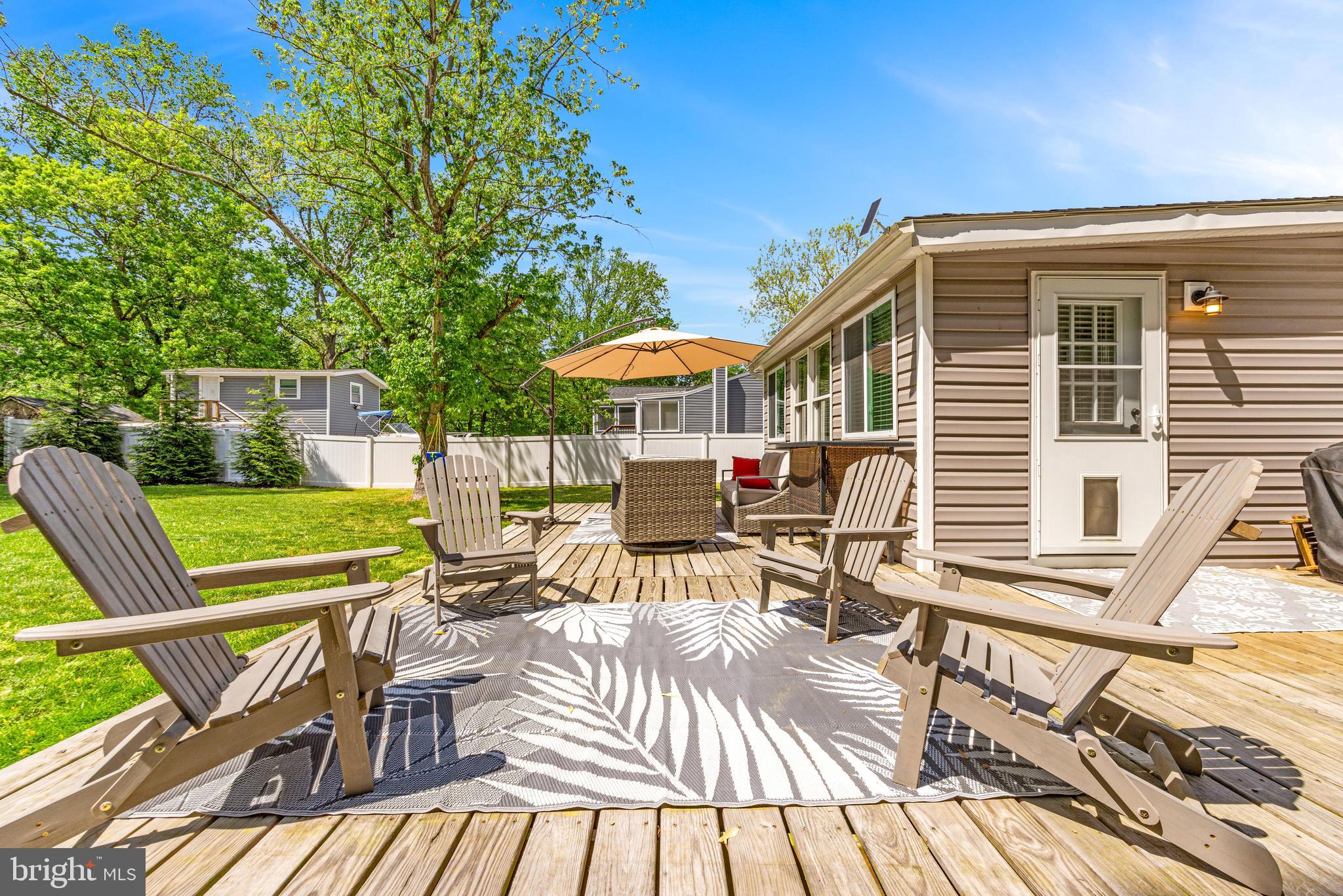 3006 Bass Place Riva, MD 21140 - Photo 45 of 51 a view of a patio with couches table and chairs and wooden floor