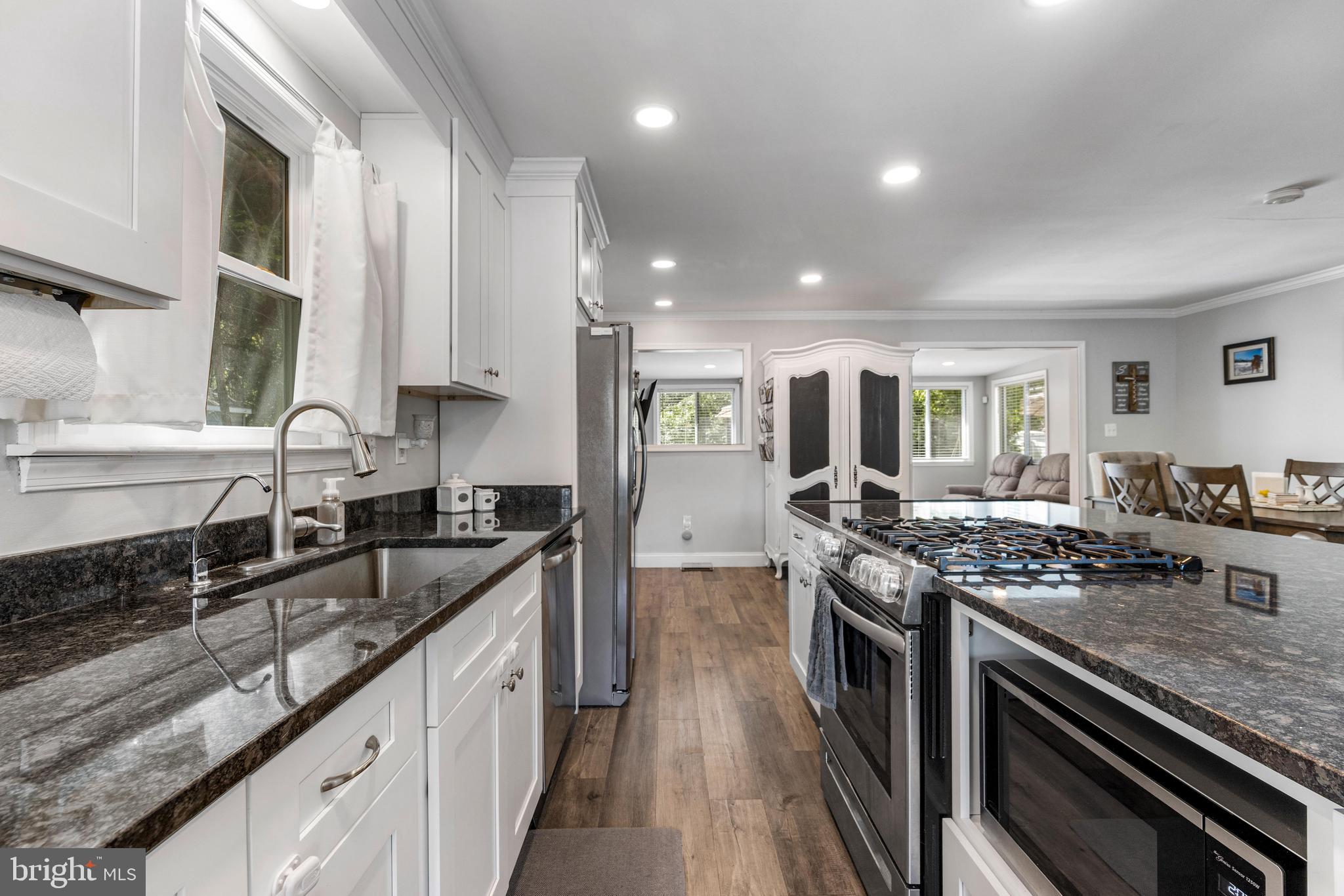 3006 Bass Place Riva, MD 21140 - Photo 8 of 51 a kitchen with stainless steel appliances granite countertop a stove sink and cabinets