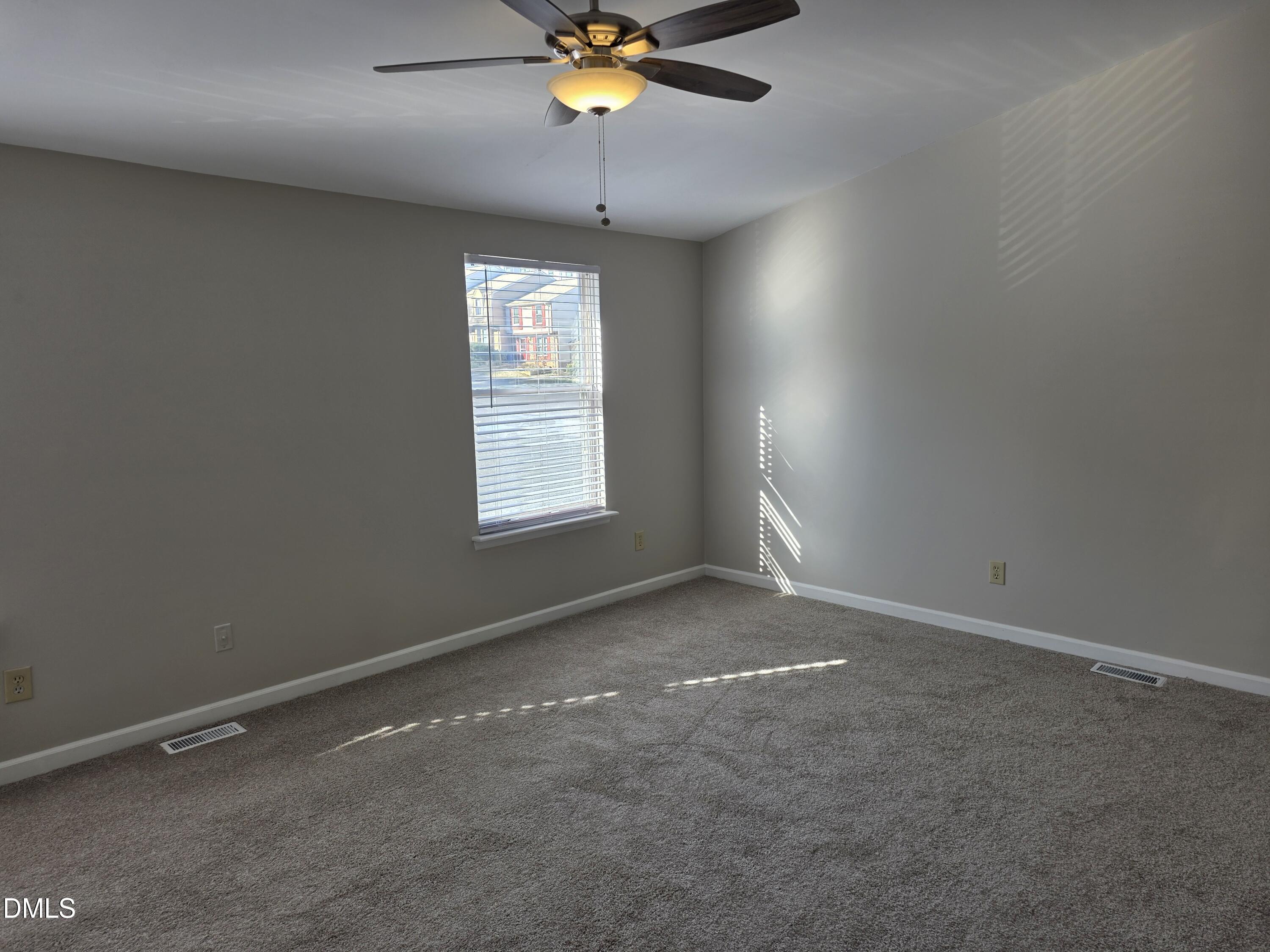 1717 Kayla Court Raleigh, NC 27606 - Photo 11 of 27 an empty room with windows and chandelier fan