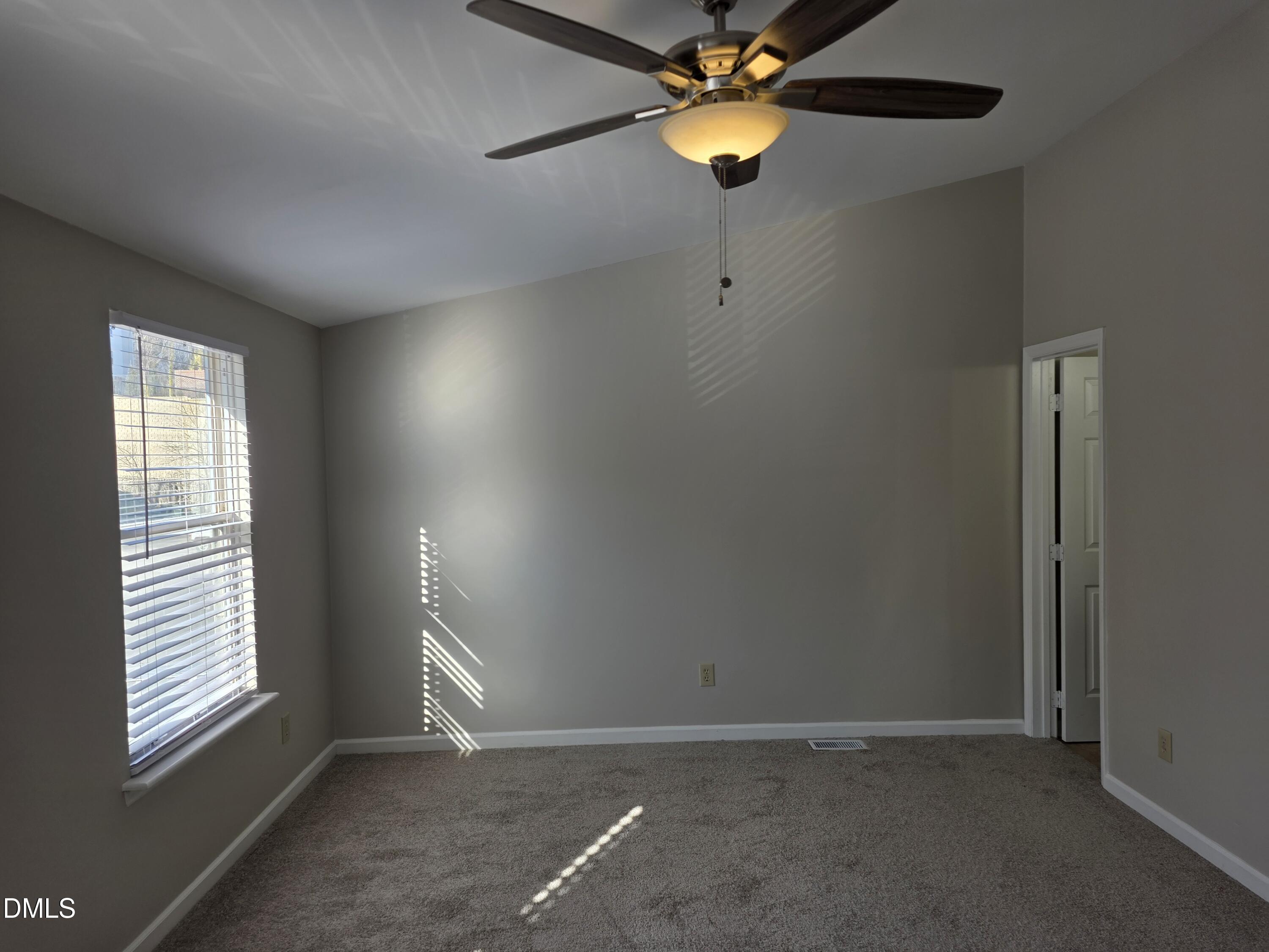 1717 Kayla Court Raleigh, NC 27606 - Photo 14 of 27 an empty room with windows and fan