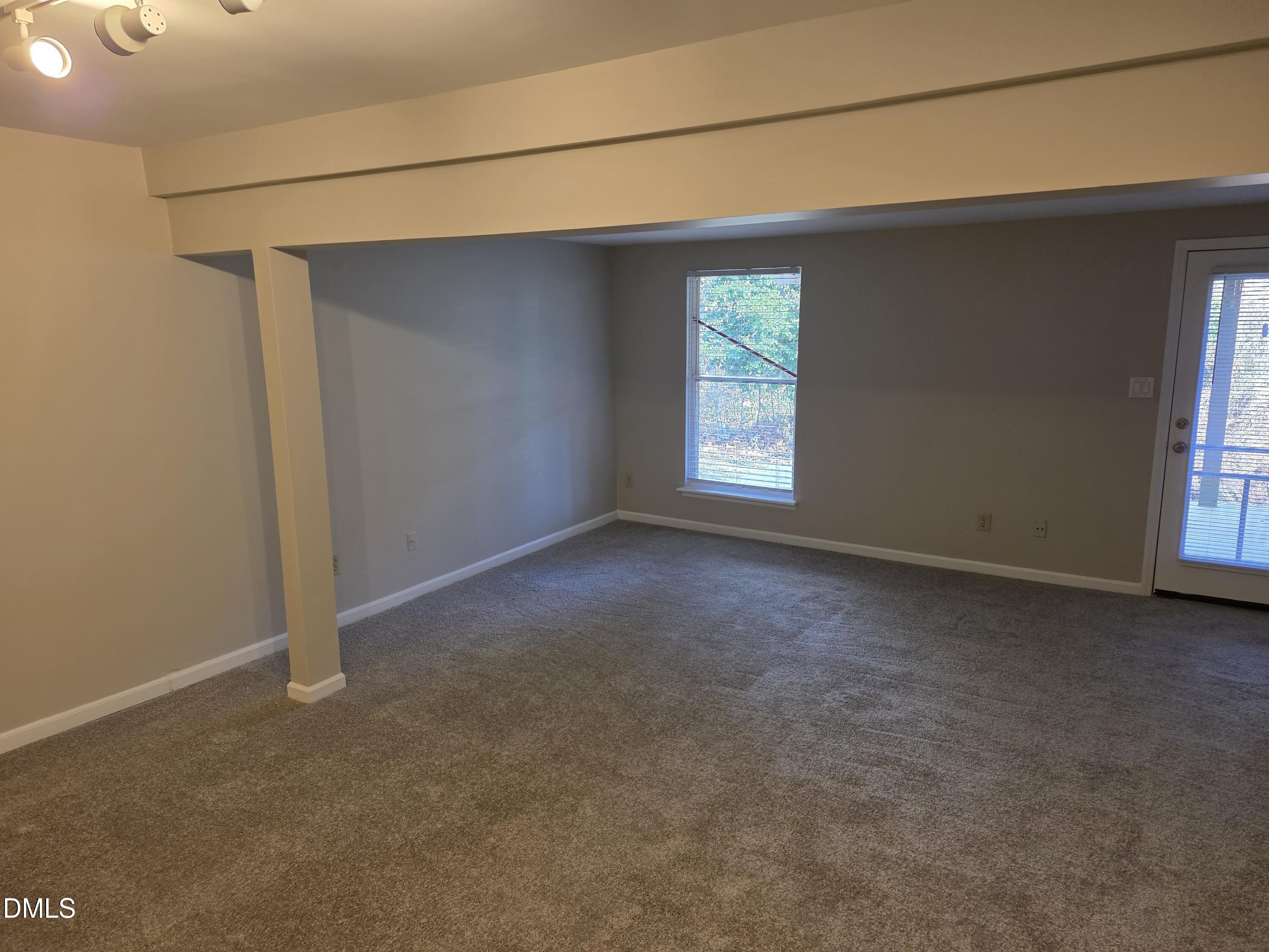 1717 Kayla Court Raleigh, NC 27606 - Photo 16 of 27 a view of a livingroom with an empty space and a window