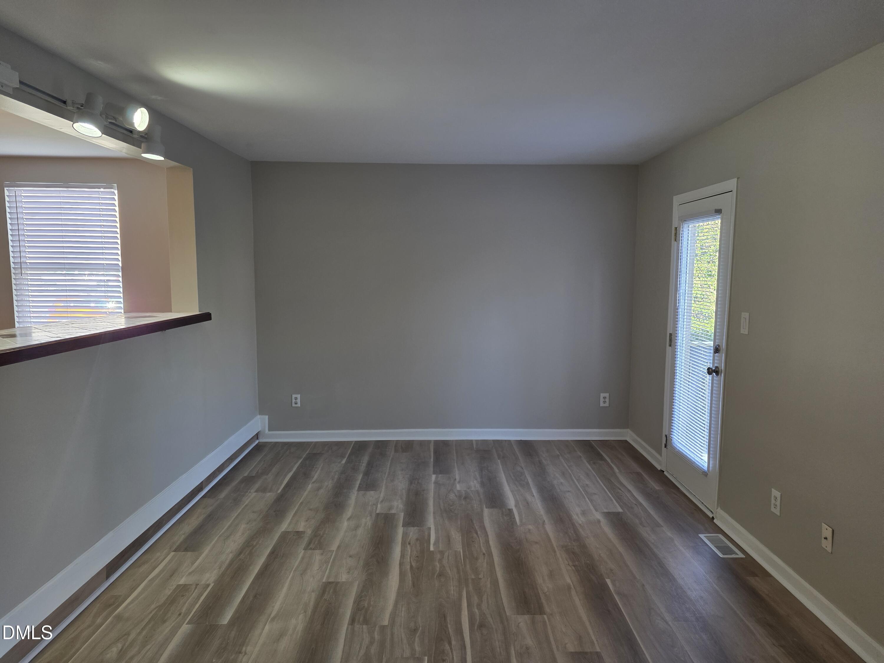 1717 Kayla Court Raleigh, NC 27606 - Photo 21 of 27 wooden floor in an empty room with a window