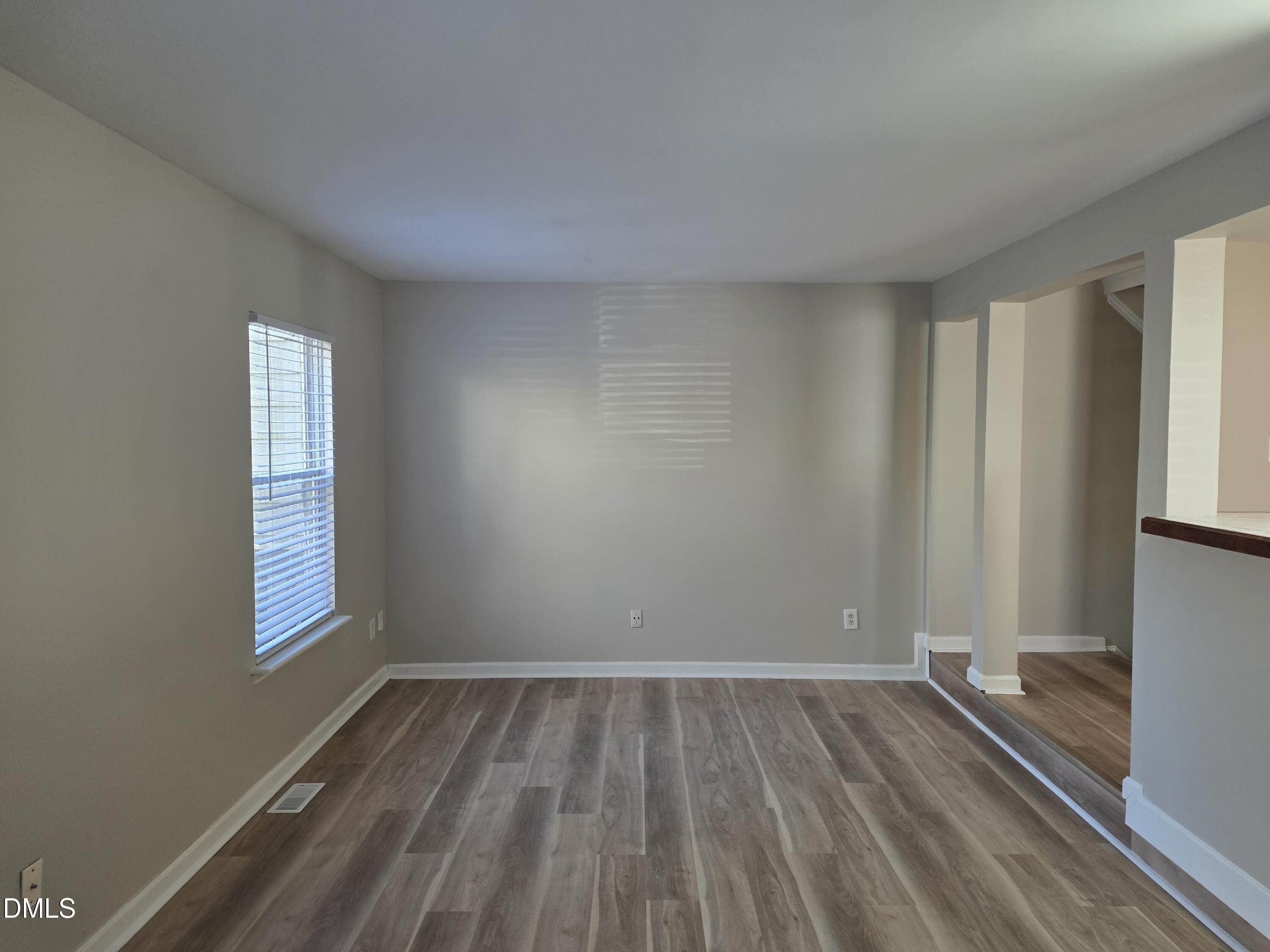 1717 Kayla Court Raleigh, NC 27606 - Photo 22 of 27 a view of a room with wooden floor and window