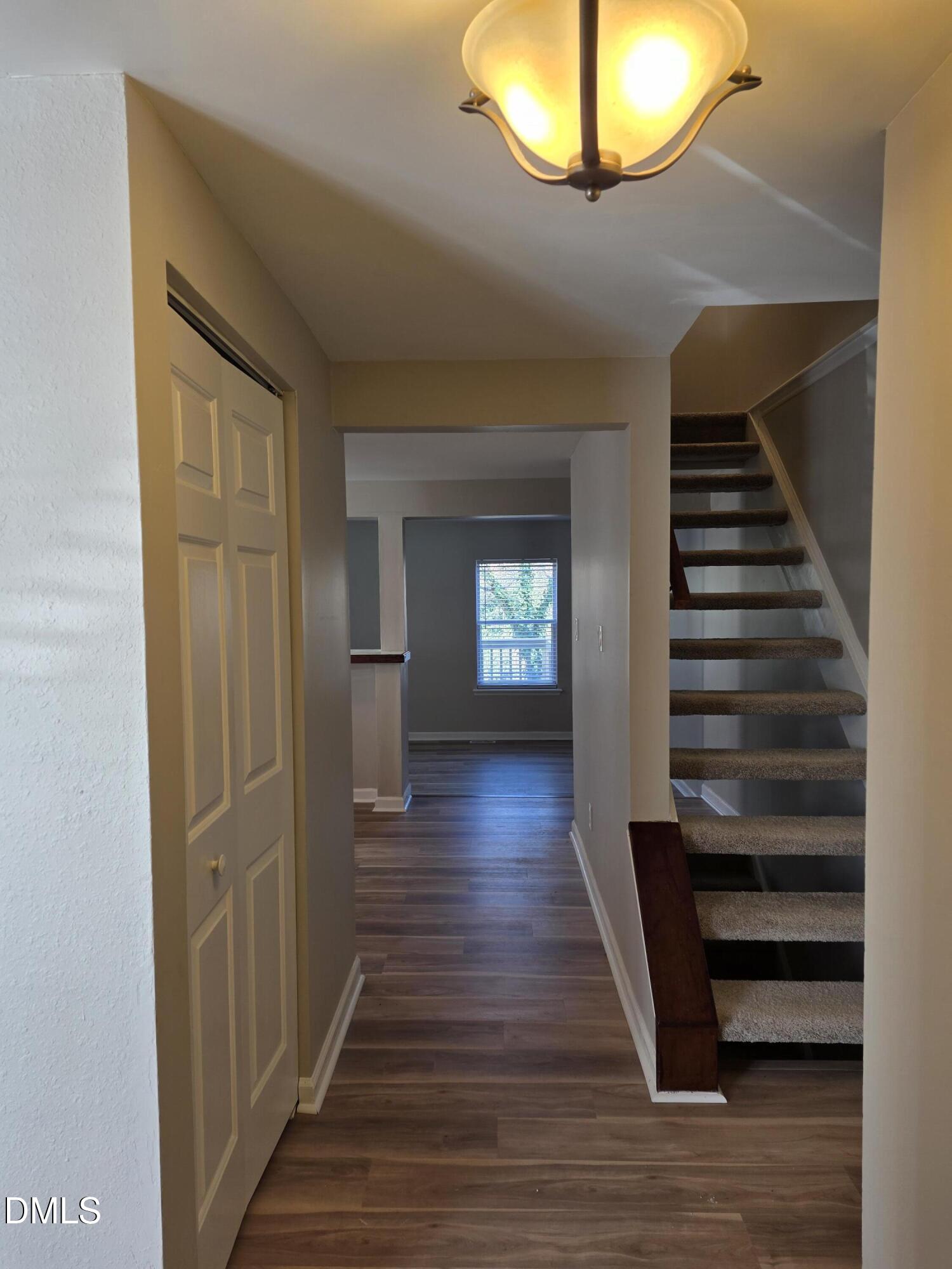 1717 Kayla Court Raleigh, NC 27606 - Photo 25 of 27 a view of a hallway with wooden floor and staircase