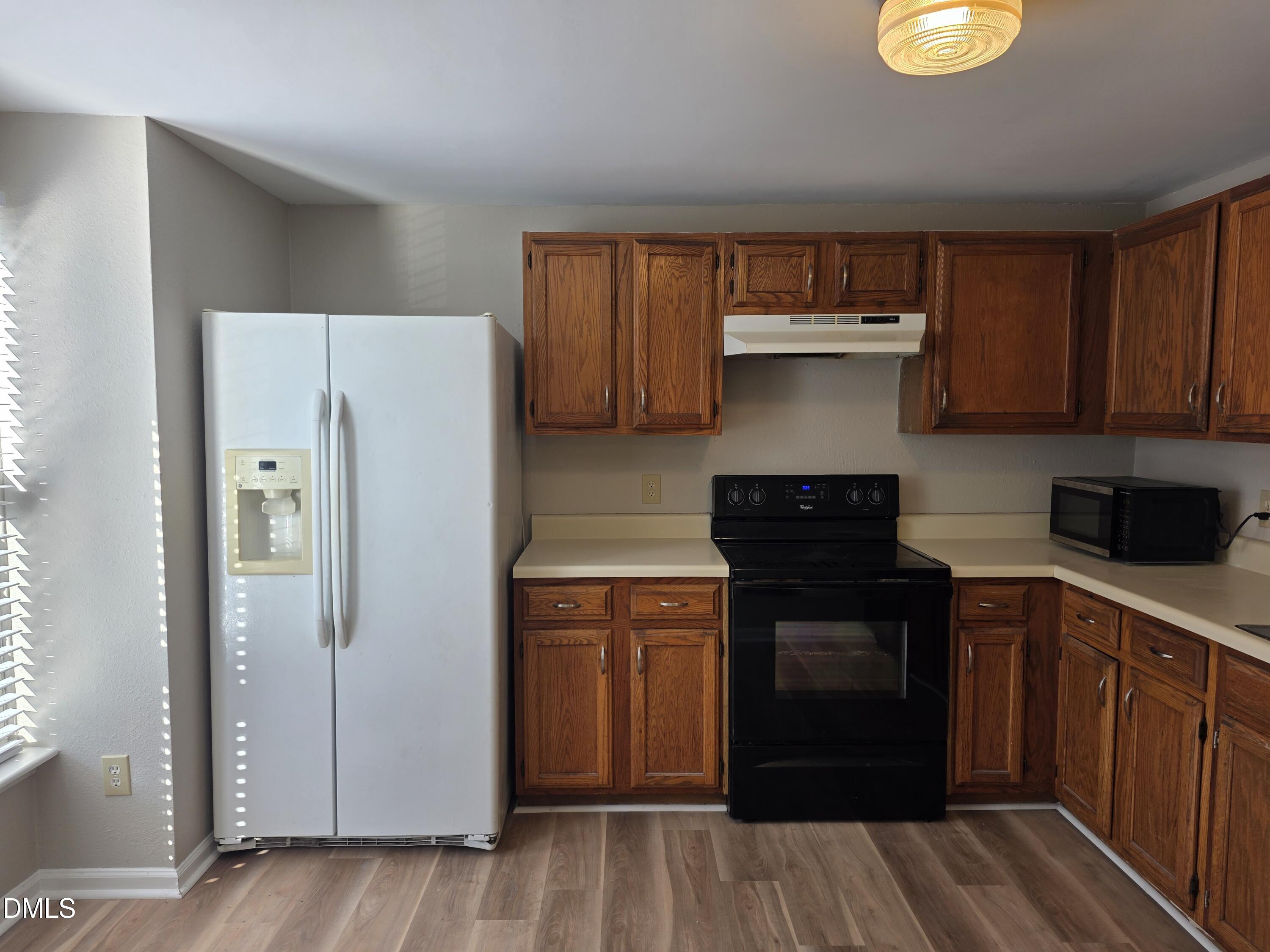 1717 Kayla Court Raleigh, NC 27606 - Photo 26 of 27 a kitchen with a refrigerator and a stove