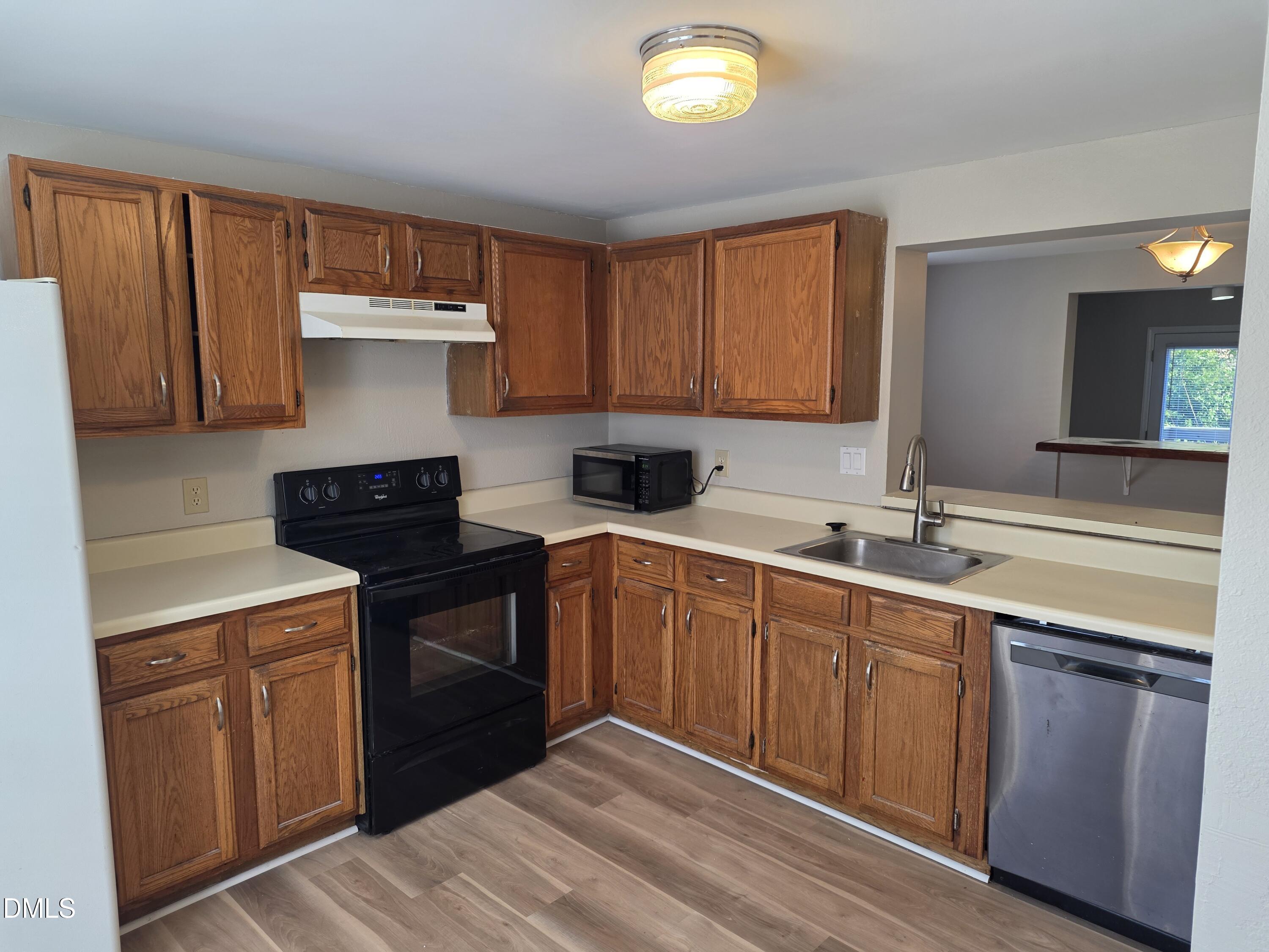 1717 Kayla Court Raleigh, NC 27606 - Photo 27 of 27 a kitchen with a sink and cabinets