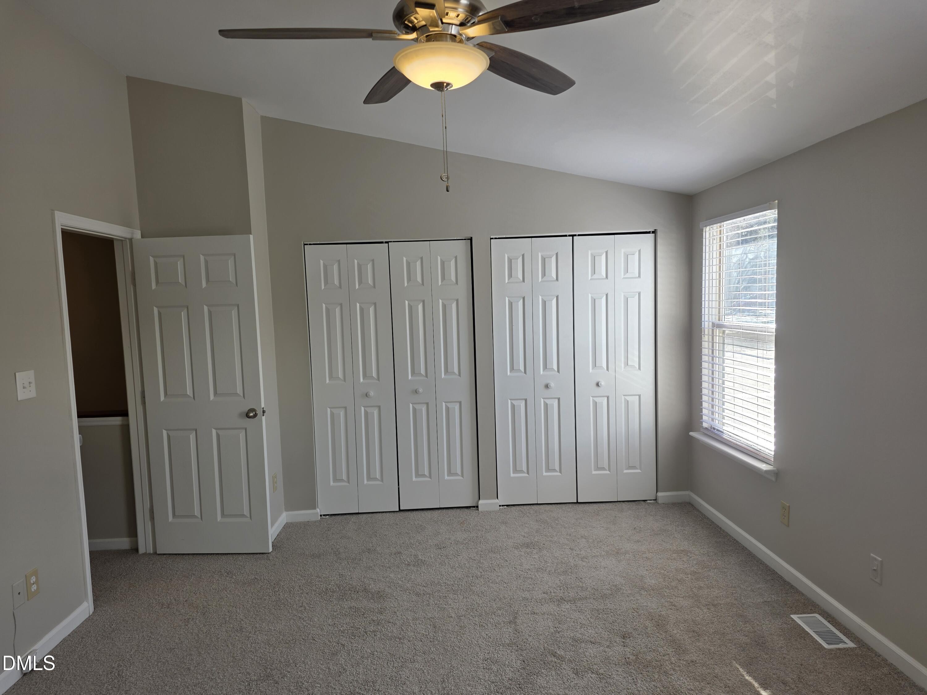 1717 Kayla Court Raleigh, NC 27606 - Photo 3 of 27 an empty room with windows and fan